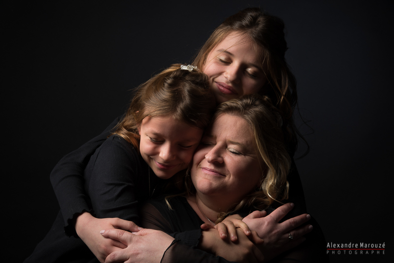 calin de deux filles et leur maman en séance famille